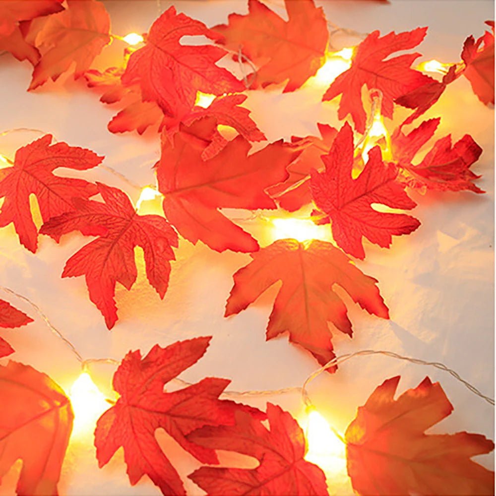 Maple Leaf LED Garland Lights – lit maple leaf string lights spread across a white surface