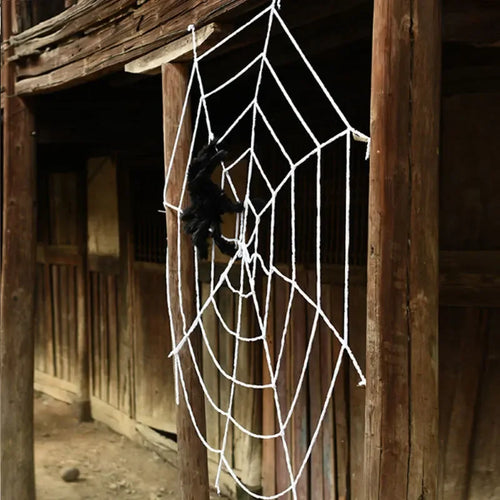 Giant Halloween Spider Web – white rope web hung across a barn doorway