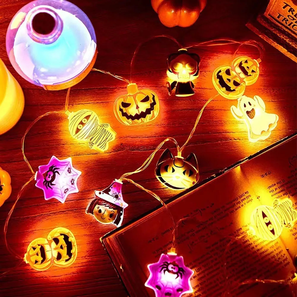 Halloween String Lights – mixed charms glowing on a table with books
