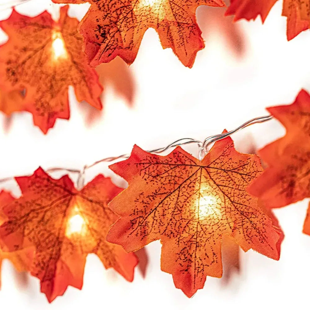 Maple Leaf LED Garland Lights – close-up of orange-red maple leaves glowing with warm white LEDs