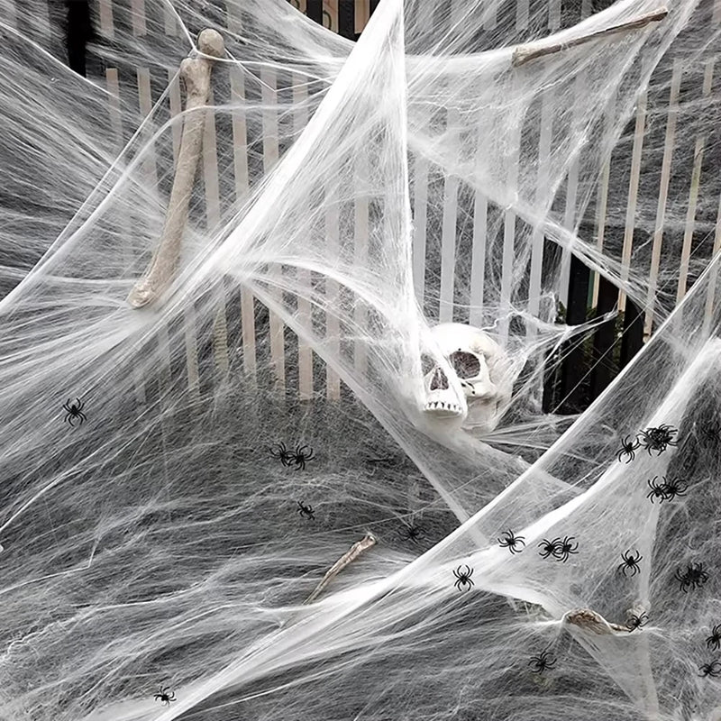 Stretchy Spider Web – white cobweb with small black spiders and a skull covering a garden fence