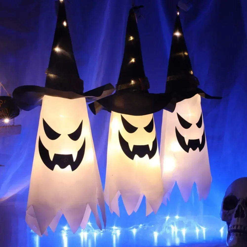 Light-Up Hanging Ghosts – three witch hat ghosts glowing warm white, with lights on their hats