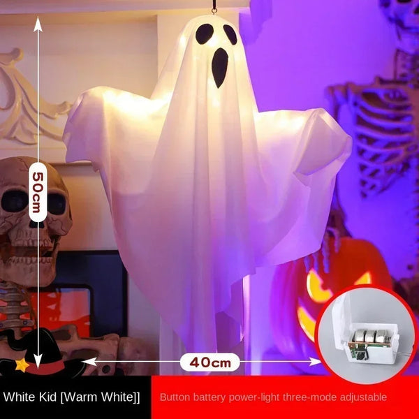 Light-Up Hanging Ghosts – white sheet ghost glowing warm white, about 50 cm tall and 40 cm wide, with its button-battery box