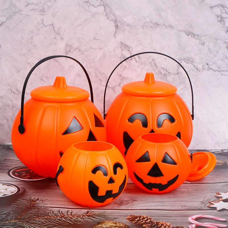 Jack-O'-Lantern Pumpkin Candy Bucket – two large lidded buckets with handles behind two small buckets, one lid set aside