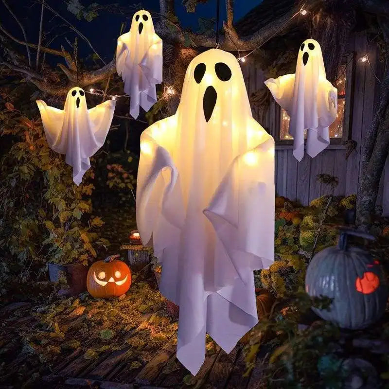Light-Up Hanging Ghosts – white sheet ghosts glowing in a yard at night