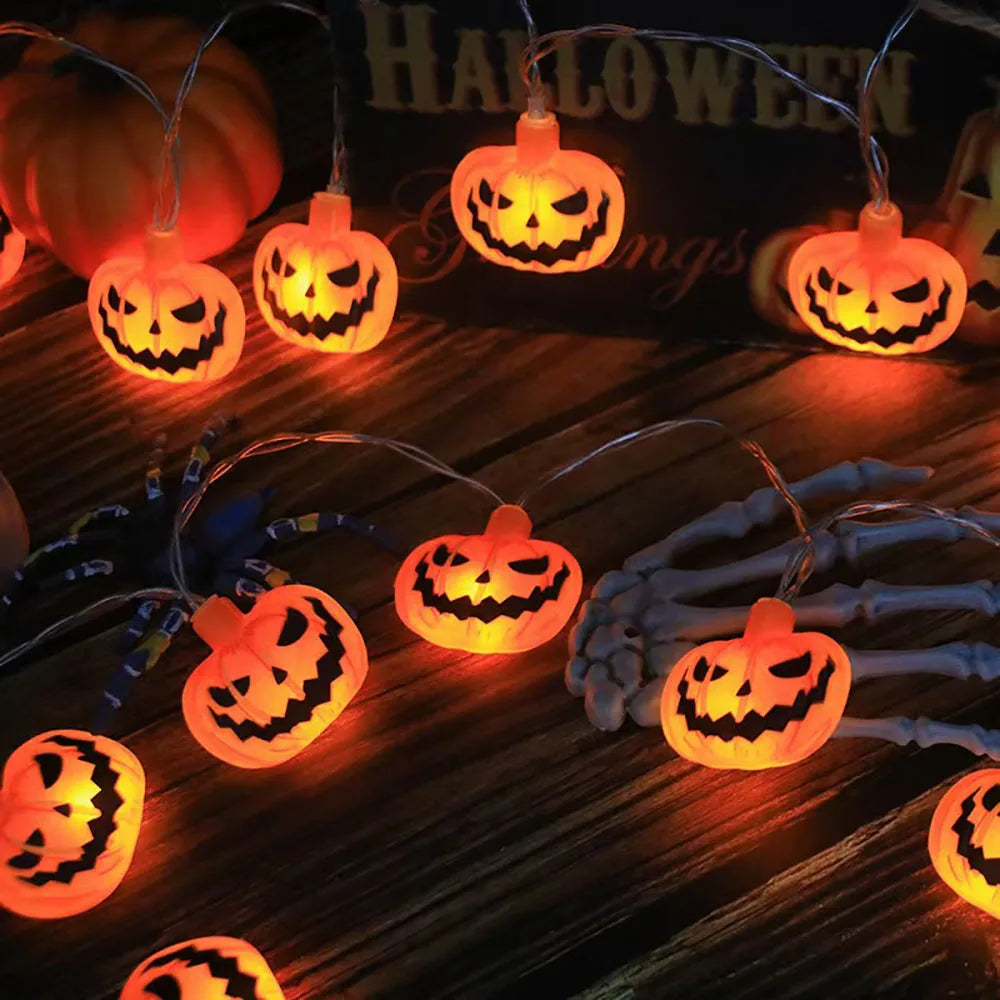 Halloween String Lights – glowing jack-o'-lantern charms on a table