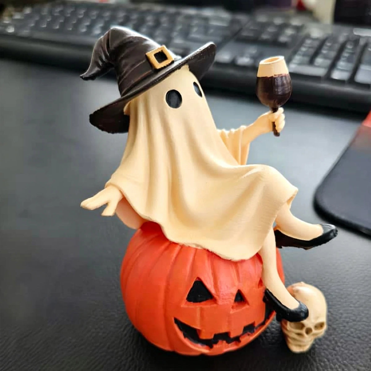 Halloween Ghost Figurine – real photo of the resin figurine on a desk in front of a keyboard