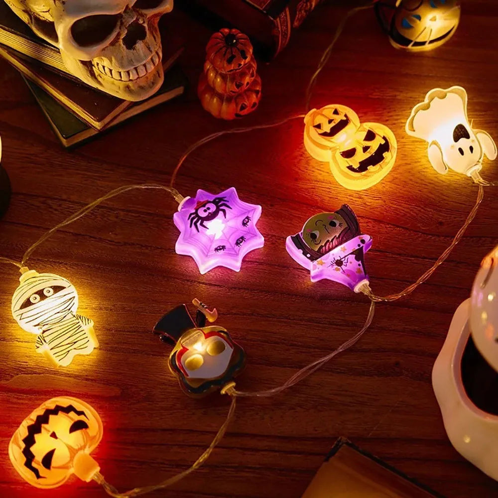 Halloween String Lights – mixed charms glowing next to a skull and books