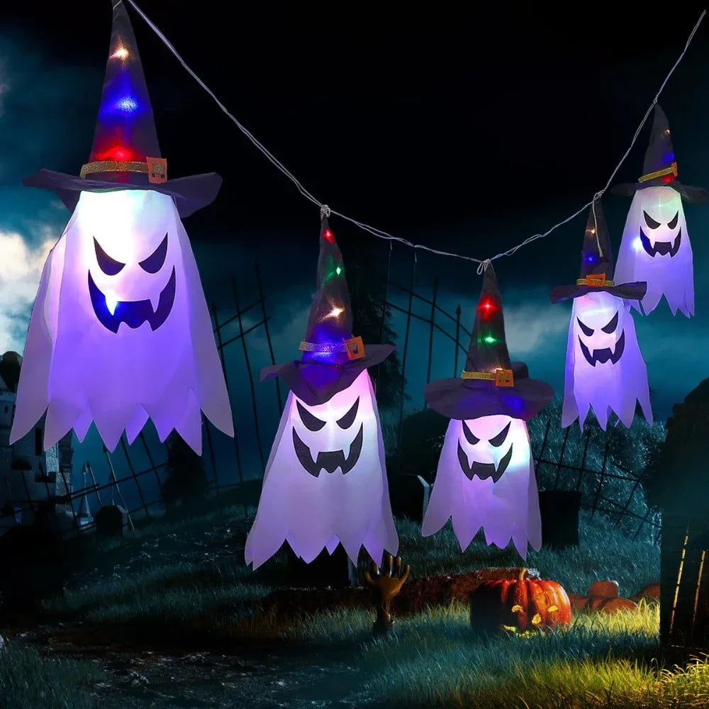 Light-Up Hanging Ghosts – multicolor witch hat ghosts hanging outdoors at night