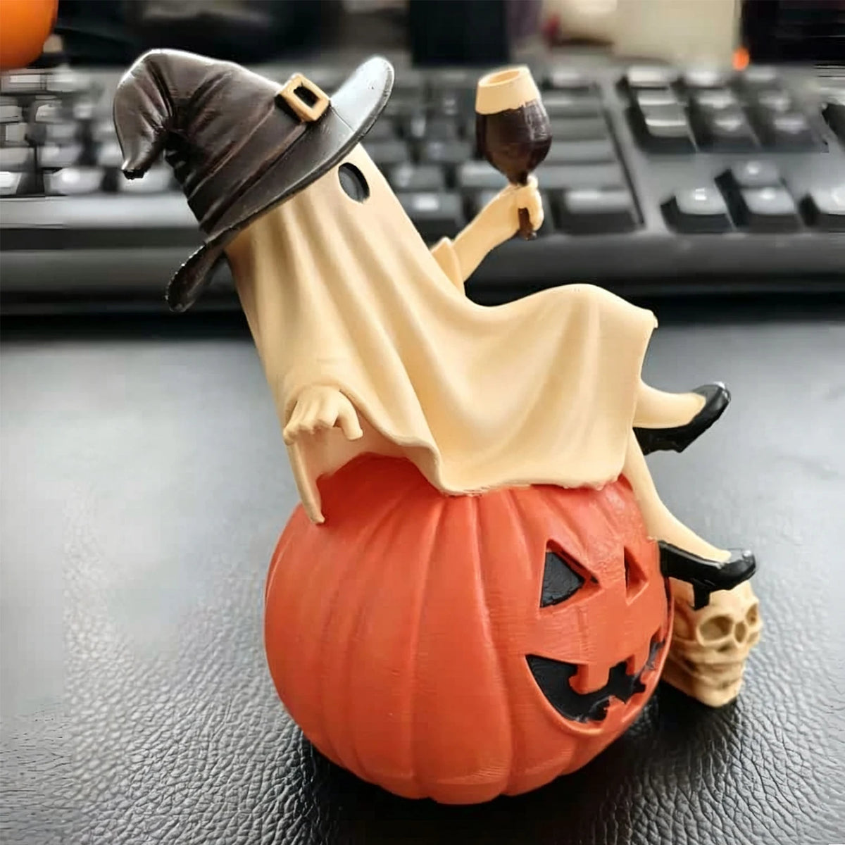 Halloween Ghost Figurine – real photo, side view of the raised wine glass and the ghost's shoes on the pumpkin