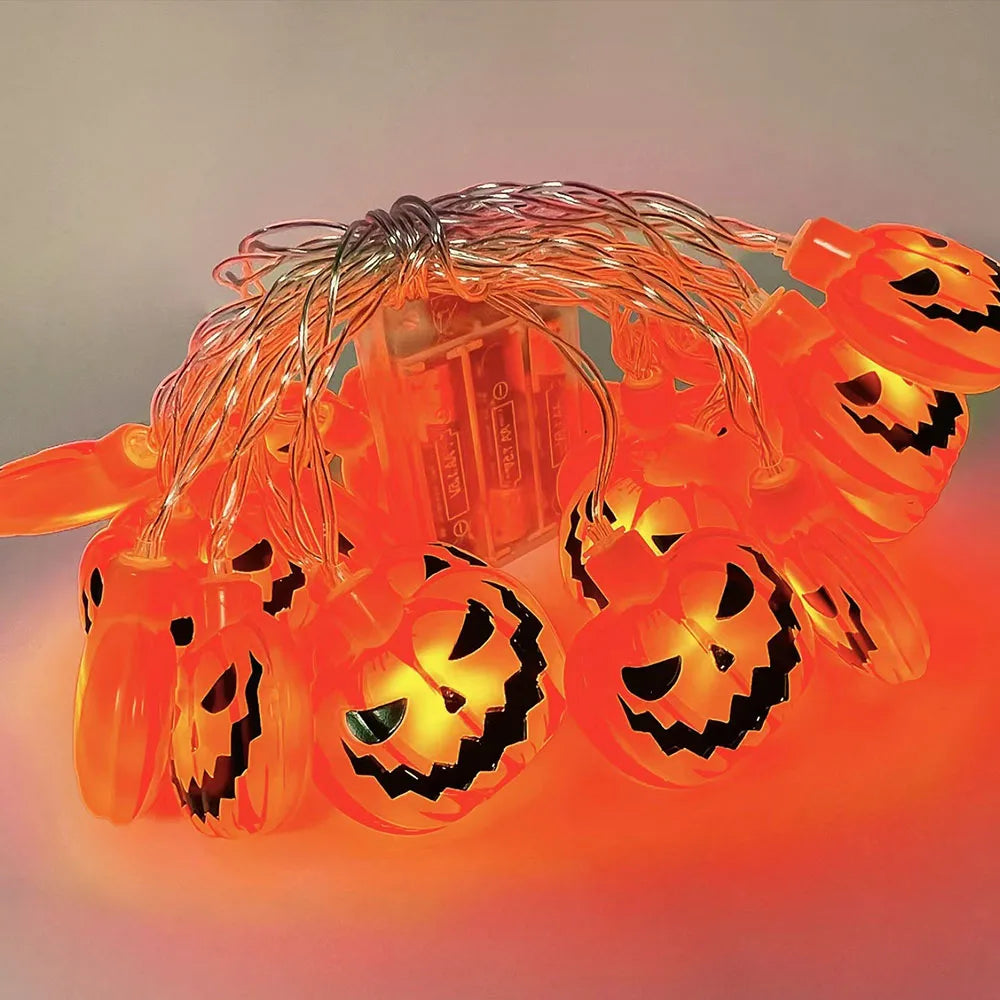 Halloween String Lights – pumpkin string lit up, with its battery box