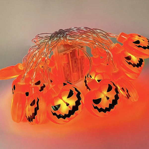Halloween String Lights – pumpkin string lit up, with its battery box