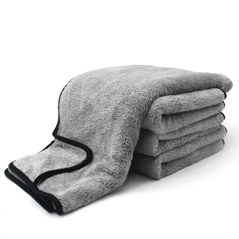Stack of gray towels with black edges on a white background